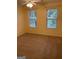 Bright bedroom with carpeted floor, ceiling fan, and two large windows at 161 Revolutionary Dr, Hampton, GA 30228
