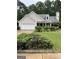 Brick and beige two-story house with a two-car garage and well-manicured lawn at 161 Revolutionary Dr, Hampton, GA 30228