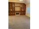 Living room featuring a large built-in wooden entertainment center and fireplace at 161 Revolutionary Dr, Hampton, GA 30228