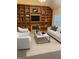 Spacious living room with built-in shelving, fireplace and neutral colored furniture at 161 Revolutionary Dr, Hampton, GA 30228