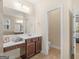 Main bathroom with toilet, vanity, and access to bedroom at 109 Faversham Dr, Mcdonough, GA 30252