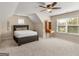 Bedroom with ceiling fan, window, and built-in wooden shelving at 109 Faversham Dr, Mcdonough, GA 30252