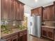 Kitchen features stainless steel refrigerator and granite countertops at 109 Faversham Dr, Mcdonough, GA 30252