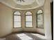 Bright bedroom with three arched windows and neutral carpeting at 232 Darwish Dr, Mcdonough, GA 30252