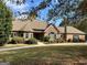 Two-story home with stone and brick exterior, and a manicured lawn at 232 Darwish Dr, Mcdonough, GA 30252