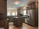 Large kitchen with an island, stainless steel appliances, and dark wood cabinets at 232 Darwish Dr, Mcdonough, GA 30252