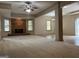 Spacious living room featuring a brick fireplace, neutral color scheme, and modern ceiling fan at 232 Darwish Dr, Mcdonough, GA 30252