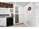 White cabinets, wine rack, and black appliances in this kitchen at 248 Montrose Dr, Mcdonough, GA 30253