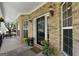 Inviting front porch with brick facade and black door at 1561 Aiken Chafin Ln, Mcdonough, GA 30252