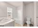 Clean bathroom featuring a tub/shower combo, toilet, and bright window at 325 Sound Cir # 137, Stockbridge, GA 30281