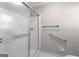 Bathroom featuring framed shower doors, safety grab bar, and sleek fixtures at 180 Lagrange Ct, Fayetteville, GA 30214