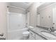 Bathroom featuring bathtub, tile surround, granite vanity and chrome hardware at 180 Lagrange Ct, Fayetteville, GA 30214