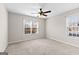 Bright bedroom featuring neutral walls, ceiling fan and two double hung windows at 180 Lagrange Ct, Fayetteville, GA 30214