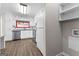 Kitchen with white cabinets, stainless steel dishwasher, countertops, sink, wood-look flooring, and laundry room at 180 Lagrange Ct, Fayetteville, GA 30214