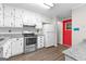 Bright kitchen featuring white cabinets, granite countertops, stainless steel appliances, and wood-look flooring at 180 Lagrange Ct, Fayetteville, GA 30214