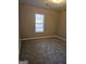 Bright bedroom featuring carpeted floors and a window at 20 Pond Ct, Stockbridge, GA 30281