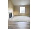 Open living room with a fireplace and large window at 62 Haver Dr, Riverdale, GA 30274
