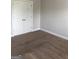 Bedroom with neutral carpeting and double door closet, offering a cozy and functional space at 284 Madison Grace Ave, Mcdonough, GA 30252