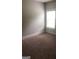 Bedroom featuring neutral carpet and natural light from a window with blinds, providing a serene space at 284 Madison Grace Ave, Mcdonough, GA 30252