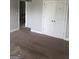 Bedroom featuring neutral carpeting, closet, and light, offering a comfortable and functional space at 284 Madison Grace Ave, Mcdonough, GA 30252