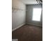 Carpeted walk-in closet with natural light from the window and shelving ready for storage at 284 Madison Grace Ave, Mcdonough, GA 30252