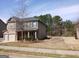 Charming two-story home with a stone and siding facade, attached garage and landscaped yard at 284 Madison Grace Ave, Mcdonough, GA 30252
