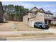 Charming two-story home with a stone and siding facade, attached garage and police vehicle in the driveway at 284 Madison Grace Ave, Mcdonough, GA 30252