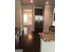 Kitchen shows stainless steel refrigerator, granite countertops, and access to dining room and hardwood flooring at 284 Madison Grace Ave, Mcdonough, GA 30252