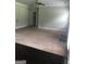 Spacious living room shows combination of carpet and hard wood flooring, with easy access to multiple rooms at 284 Madison Grace Ave, Mcdonough, GA 30252