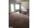 Open-concept living room featuring neutral carpet, black hardwood, natural light, and a chandelier at 284 Madison Grace Ave, Mcdonough, GA 30252