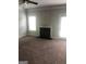 Cozy living room features a fireplace, carpeted floor and abundant light with access to the outdoors at 284 Madison Grace Ave, Mcdonough, GA 30252