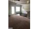 Bright living area with carpet flooring, with view into the dining area and the outdoor access door at 284 Madison Grace Ave, Mcdonough, GA 30252
