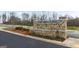 Stone entrance sign reading 'Echo Glen' with flowerbed and landscaping in front of the new neighborhood at 317 Sound Cir # 139, Stockbridge, GA 30281