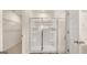 Bathroom features a glass-enclosed shower with built in shelving and wood look tile at 321 Sound Cir # 138, Stockbridge, GA 30281