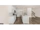 Modern kitchen with white cabinets, stainless steel appliances, an island, and hardwood floors at 321 Sound Cir # 138, Stockbridge, GA 30281