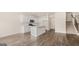 Bright, modern kitchen with white cabinets, stainless steel appliances, an island, and hardwood floors at 321 Sound Cir # 138, Stockbridge, GA 30281
