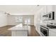 Bright, modern kitchen with white cabinets, stainless steel appliances, an island, and hardwood floors at 321 Sound Cir # 138, Stockbridge, GA 30281