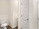 View of the home's toilet with a white toilet seat and wood flooring at 321 Sound Cir # 138, Stockbridge, GA 30281