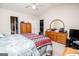 Vaulted ceiling bedroom featuring a wooden dresser with mirror and ceiling fan at 1391 Lakeview Pkwy, Villa Rica, GA 30180