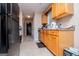 Kitchen with light wood cabinets, black appliances, and view of hallway at 1391 Lakeview Pkwy, Villa Rica, GA 30180
