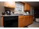 Kitchen with light wood cabinets and black appliances at 1391 Lakeview Pkwy, Villa Rica, GA 30180