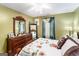 Spacious bedroom featuring a floral comforter and dresser at 106 Old Gettysburg Way, Dallas, GA 30157
