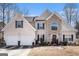 Two-story house with stone accents and a two-car garage at 106 Old Gettysburg Way, Dallas, GA 30157