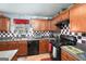 Kitchen with wood cabinets, granite countertops, and stainless steel appliances at 106 Old Gettysburg Way, Dallas, GA 30157