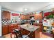 Kitchen with island, wood cabinets, and stainless steel appliances at 106 Old Gettysburg Way, Dallas, GA 30157