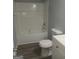 Updated bathroom with white bathtub, toilet and vanity, gray flooring at 1059 Garibaldi Sw St, Atlanta, GA 30310