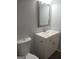 Updated bathroom with white vanity, modern mirror, and gray flooring at 1059 Garibaldi Sw St, Atlanta, GA 30310