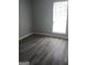 Simple bedroom with large window and vinyl flooring at 1059 Garibaldi Sw St, Atlanta, GA 30310
