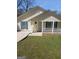 Cute yellow house with teal shutters, white porch, and a well-maintained lawn at 1059 Garibaldi Sw St, Atlanta, GA 30310