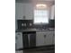 Modern kitchen with white cabinets, granite countertops, and stainless steel appliances at 1059 Garibaldi Sw St, Atlanta, GA 30310